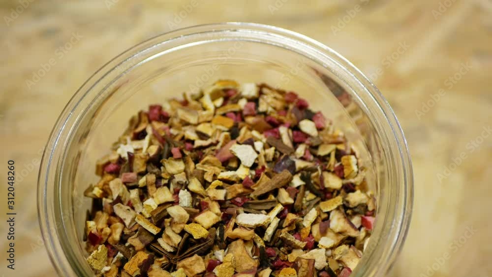 Herbal tea dried blend of rose glass jar cup, apple, lemon peel, cranberry, orange peel, star anise winter punch, cloves, cinnamon tea well decorative. Traditional folk medicine fruit, human health Herbal tea dried blend of rose glass jar cup, apple, lemon peel, cranberry, orange peel, star anise winter punch, cloves, cinnamon tea well decorative. Traditional folk medicine fruit, human health