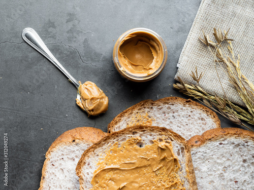 Wallpaper Mural Peanut butter in glass bottle with whole wheat bread prepare for meal. Copy space and selective focus. Torontodigital.ca