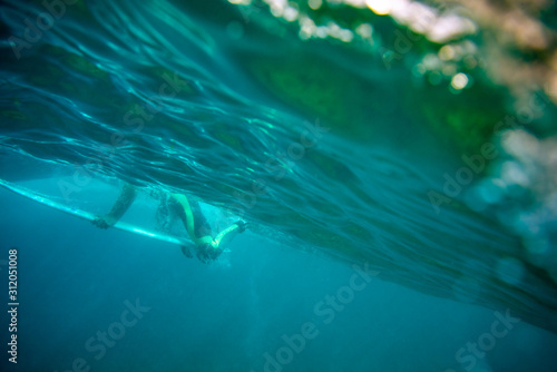 surfer passes the wave by diving, fuerteventura island © Simone Tognon