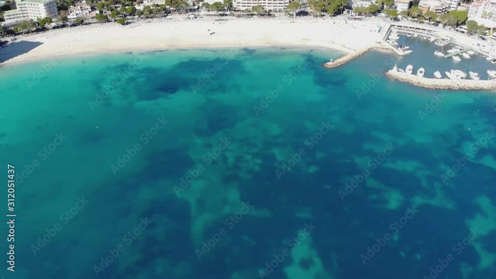 Aerial view of beautiful white sand beach without people, turquoise crystal clear water and resort coastline. Mediterranean sea, Mallorca island, Baleares, Spain. 4K cinematic footage, bird eye angle Aerial view of beautiful white sand beach without people, turquoise crystal clear water and resort coastline. Mediterranean sea, Mallorca island, Baleares, Spain. 4K cinematic footage, bird eye angle