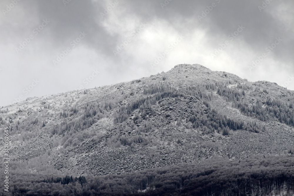 A mountain peak in the snow. Bad grey weather. Vitosha mountain.