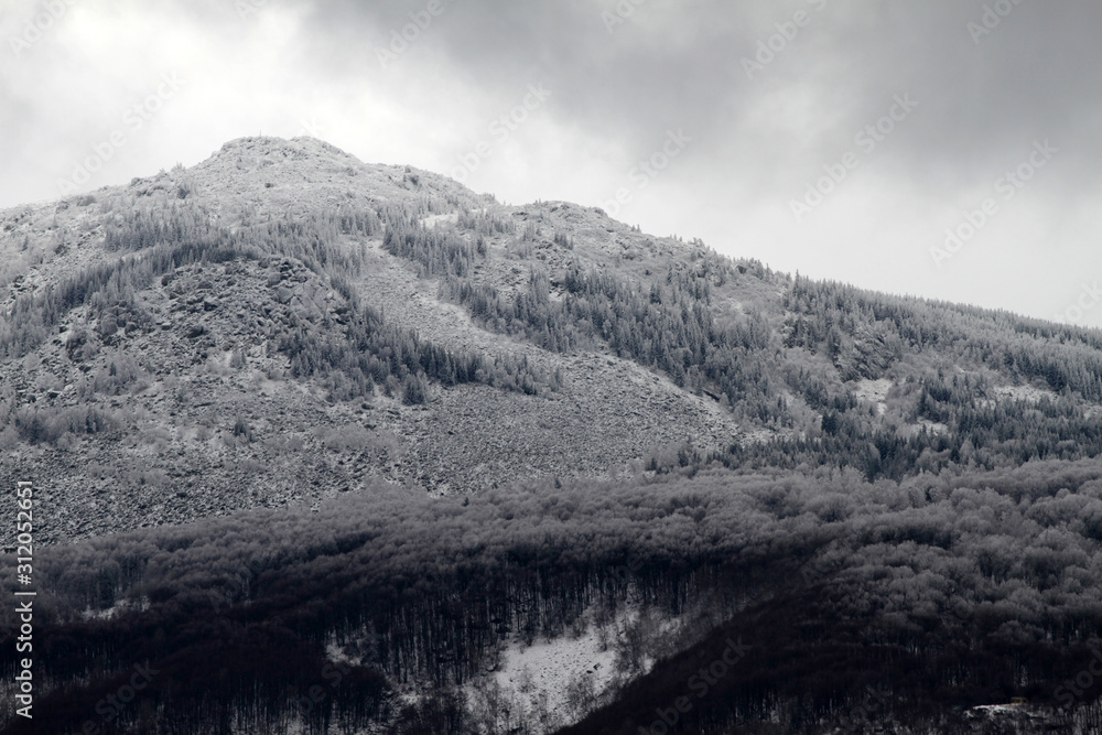 A mountain peak in the snow. Bad grey weather. Vitosha mountain.