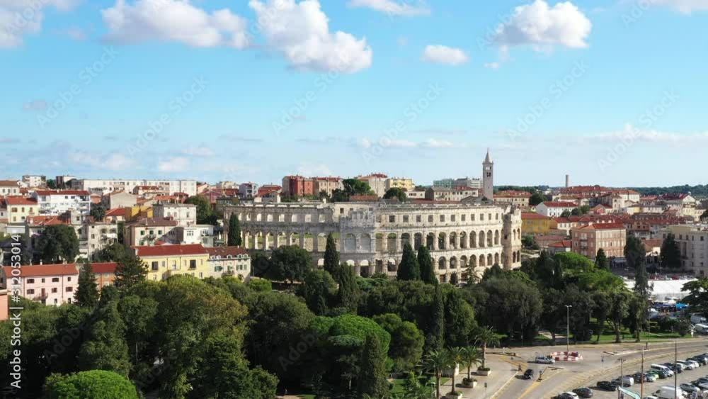 Croatia, Istria, city of Pula, ancient Roman arena, historic amphitheater and harbor with ships from drone, aerial view Croatia, Istria, city of Pula, ancient Roman arena, historic amphitheater and harbor with ships from drone, aerial view