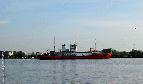 Picture of a large red boat on the river On a sunny day