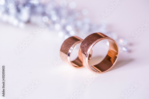 Gold wedding rings with bride decorations in the interior. Winter style 