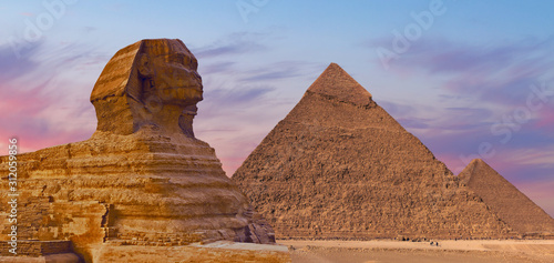 Sphinx against the backdrop of the great Egyptian pyramids. Africa  Giza Plateau. 