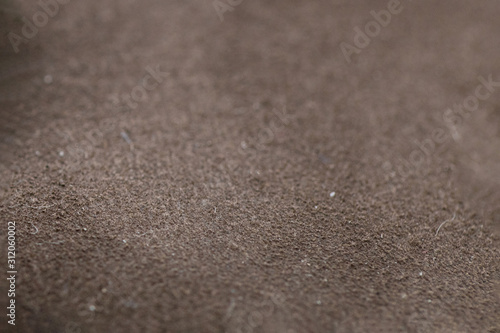 Close-up photograph of brown suede surface, texture
