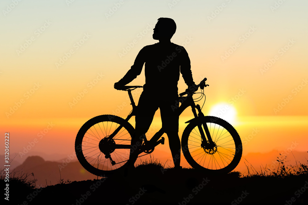 Conquering mountain peaks by cyclist in shorts and jersey on a modern carbon hardtail bike with an air suspension fork . Beautiful view from the mountain. Panoramic view for banner. Conquering mountain peaks by cyclist in shorts and jersey on a modern carbon hardtail bike with an air suspension fork . Beautiful view from the mountain. Panoramic view for banner.