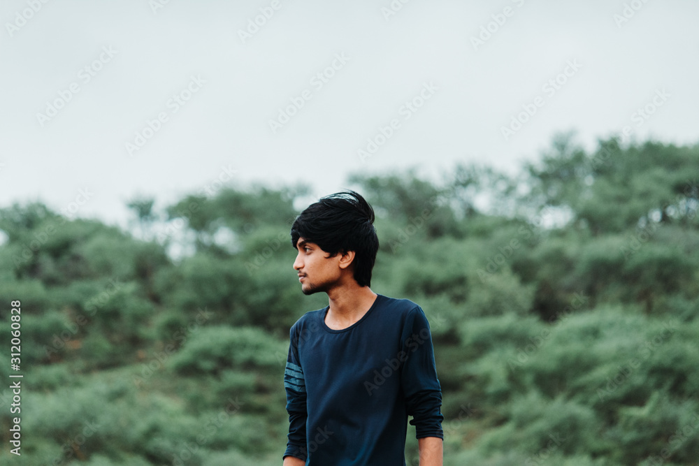 Indian male model with long hair looking sideways in Wankaner, Gujarat,  India Stock Photo | Adobe Stock