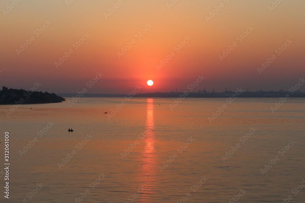 Beautiful summer sun over the horizon of the river
