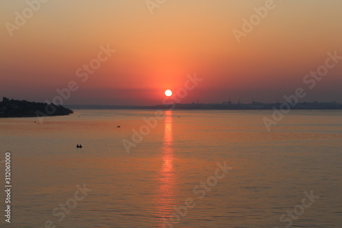 Beautiful summer sun over the horizon of the river