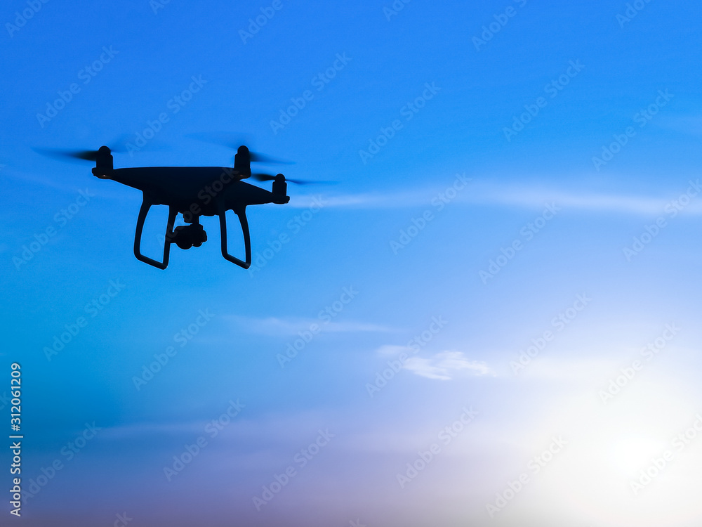 Quadrocopters silhouette against the background of the sunrise Quadrocopters silhouette against the background of the sunrise