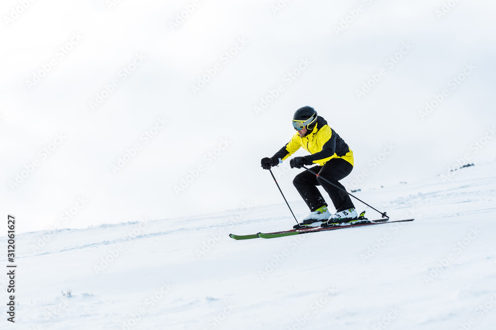 sportsman in helmet and goggles skiing on slope in winter sportsman in helmet and goggles skiing on slope in winter