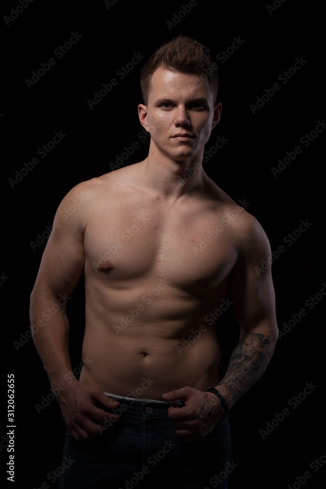 Fototapeta premium portrait of a beautiful fashionable strong man with a bare torso