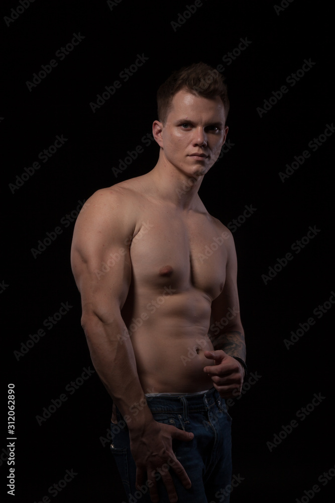 Fototapeta premium portrait of a beautiful fashionable strong man with a bare torso