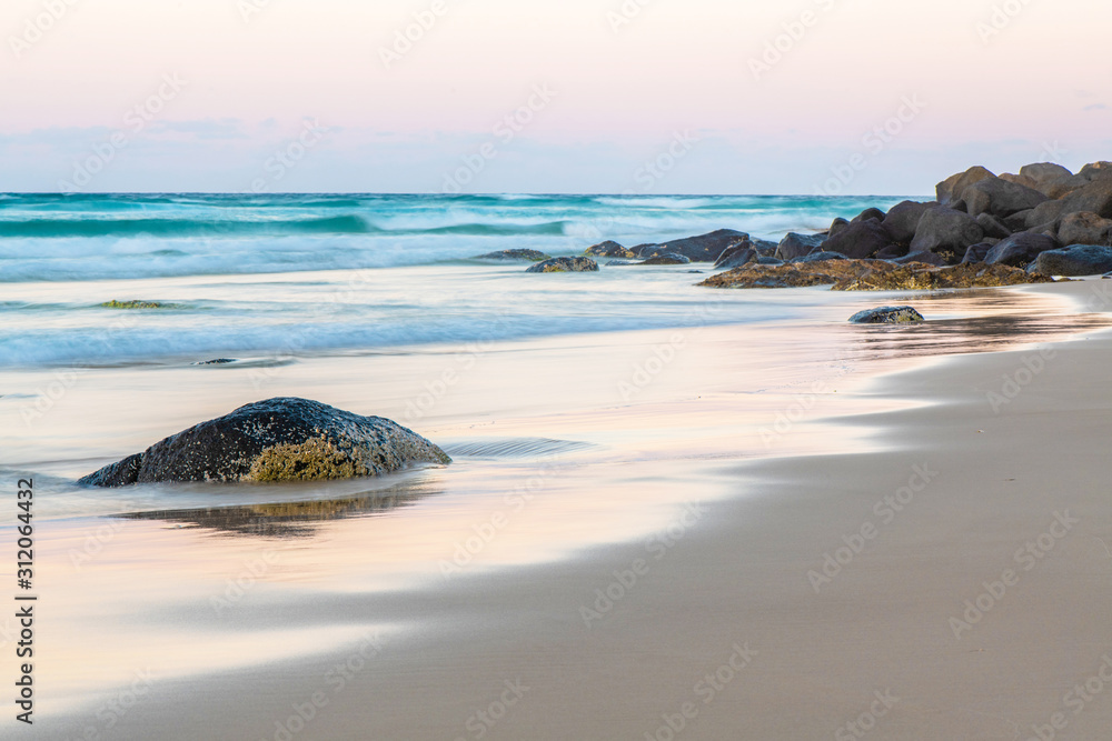 stone on beach at sunrise