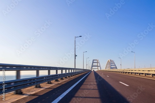 view of the road communication of the Crimean bridge from a moving car on a summer day © Andrey Solovev