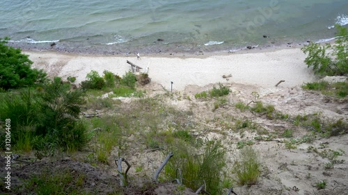 Gdynia cliff in Poland, a log where wedding couples take pictures captured with full frame camera and gimbal with scenery in the background. Dark clouds before storm.