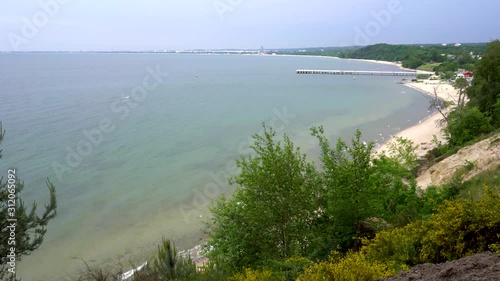 Gdynia cliff in Poland, a log where wedding couples take pictures captured with full frame camera and gimbal with scenery in the background. Dark clouds before storm.