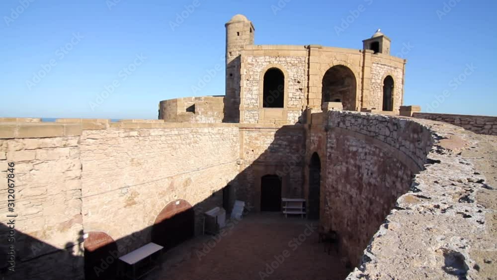Panning to the left showing the fortified tower and wall of Essaouira, Morocco. Panning to the left showing the fortified tower and wall of Essaouira, Morocco.