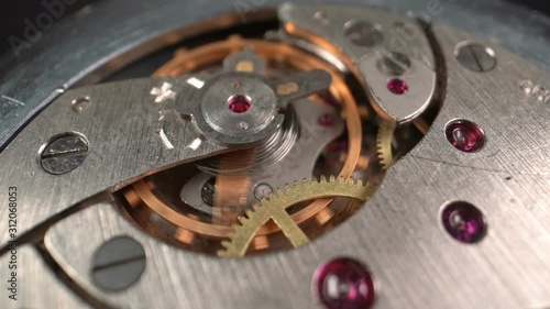 Wallpaper Mural The interiors of an old working mechanical watch with rotating gears and a pendulum. Slow motion Torontodigital.ca