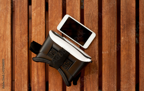 Virtual reality headset phone on wooden background