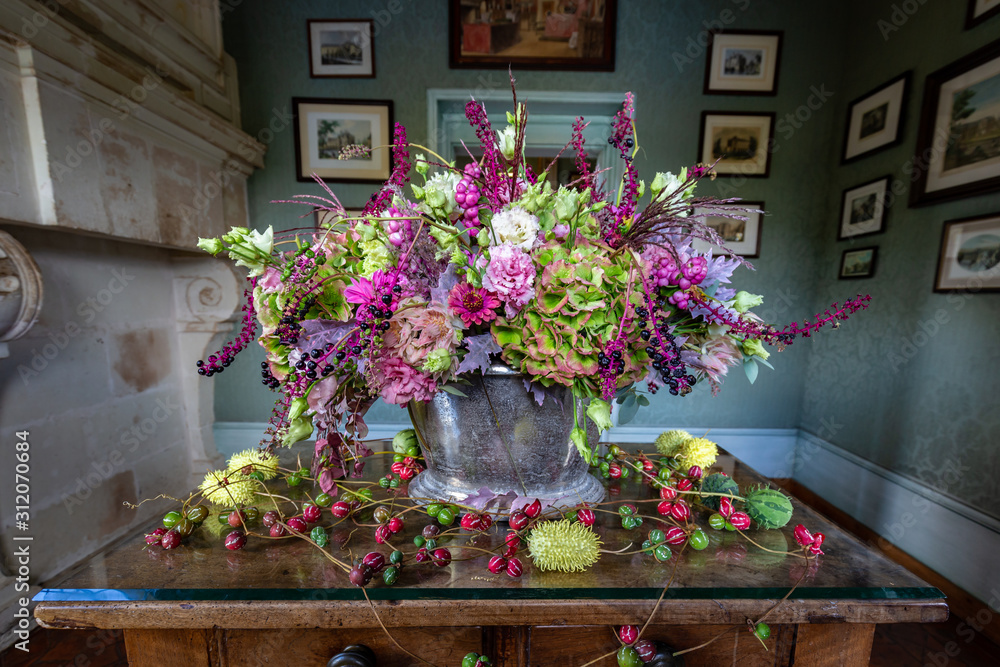 Beautiful green pink and purple flower arrangement in autumn colors in a castle setting
