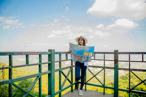 Wallpaper Mural An Asian woman is traveling to see the breathtaking view in the morning with a map of the viewpoint of Wat Phra That Doi Suthep, Chiang Mai, Thailand. Torontodigital.ca