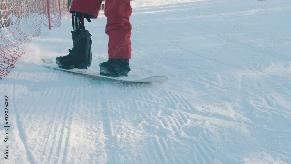 Snowboarding A man with prosthetic leg skating down the mountain and