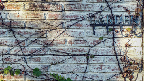 Old White Brick Wall with the GARDEN Text for Exterior Works, Background, Backdrop, or Wallpaper.