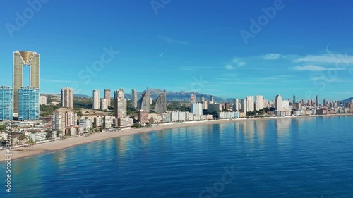Benidorm - Mediterranean cityscape at sunrise. Spanish coast and high rise skyline of benidorm seaside resort. Aerial wide angle view at this summer holiday destination.  photo
