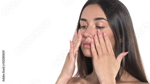 Wallpaper Mural Close-up of a woman doing face massage. Isolated, on white background. Beauty and skincare concept Torontodigital.ca