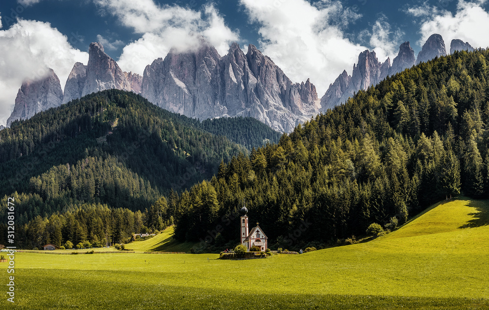 Wonderful Sunny Landscape of Dolomite Alps. St Johann Church, Santa Maddalena, Val Di Funes, Dolomites, Italy. Fairy velley in Dolomites mountains under sunlit. Amazing nature Background. Epic Scenery