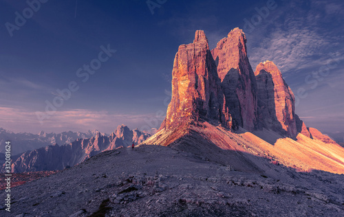 Awesome alpine highlands during sunrise. Amasing nature landscape. Tre Cime di Laveredo, three spectacular mountain peaks with colorful sky, Dolomites Alps, South Tyrol, Italy. Picture of wild area