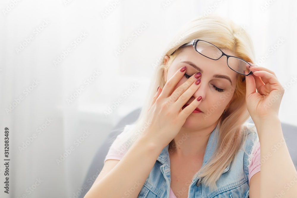 yawning woman sitting on sofa at home yawning woman sitting on sofa at home