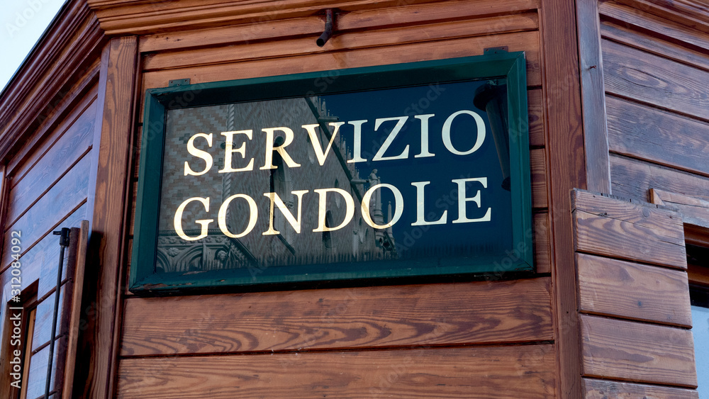 Gondola Service sign next to a canal in Venice. Gondola Service sign next to a canal in Venice.