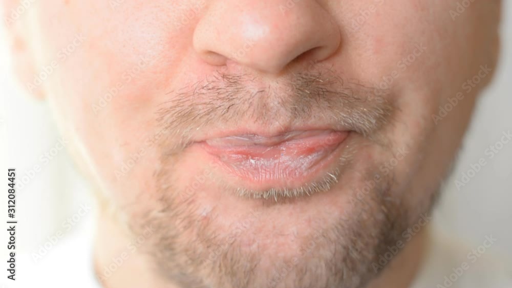 Extreme closeup man face taking white pill Extreme closeup man face taking white pill