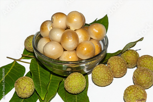 Top view of Dimocarpus longan.A bunch of Longan fruits with green leaves on white isolated background. photo