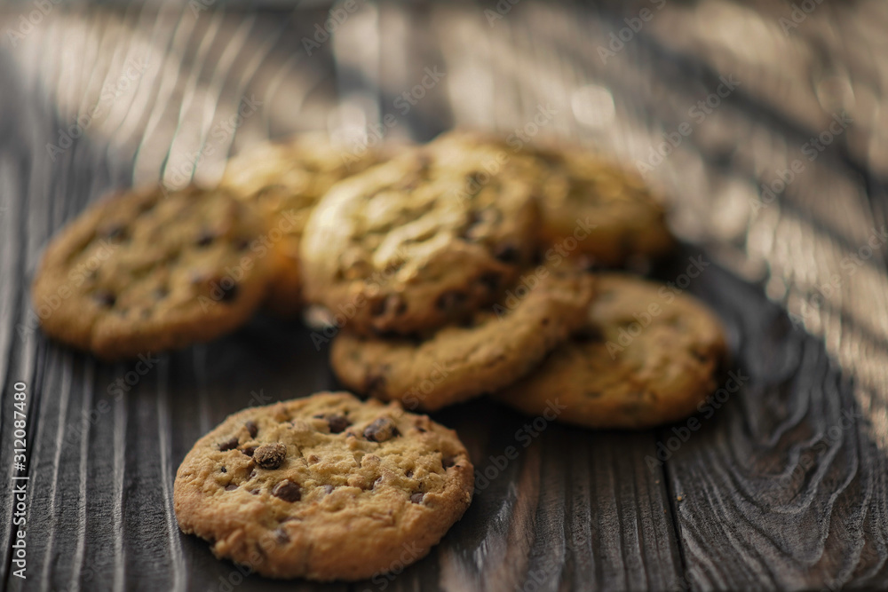 shortbread cookies with peanuts and chocolate on a wooden brown background. close-up. shortbread cookies with peanuts and chocolate on a wooden brown background. close-up.