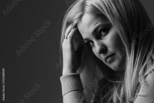 A young woman in prayer under dramatic light. Fototapeta