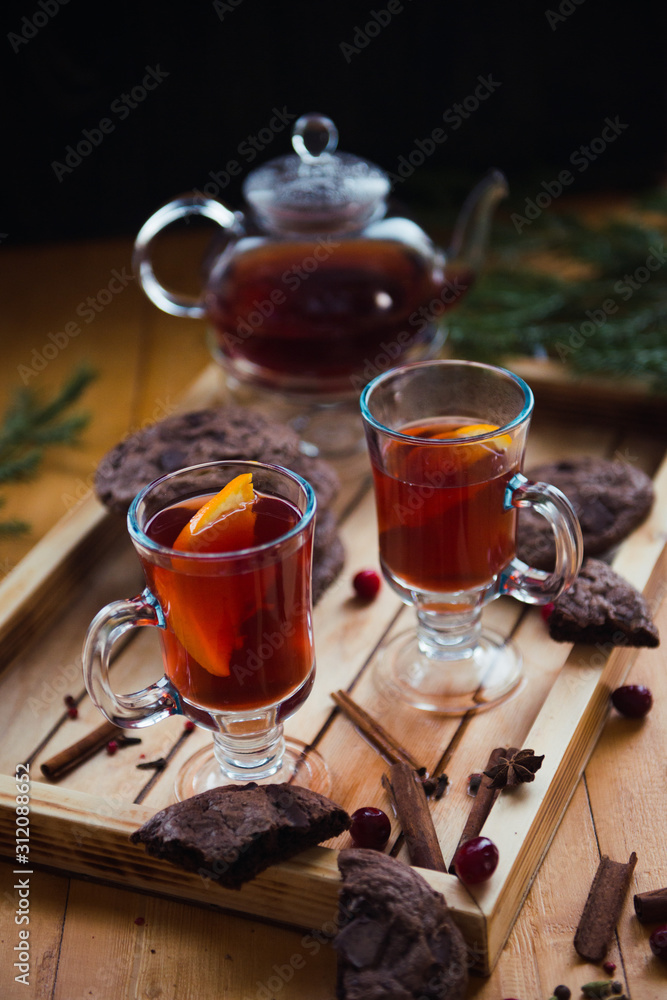 winter still life with fruit tea and chocolate cookies on wooden background winter still life with fruit tea and chocolate cookies on wooden background