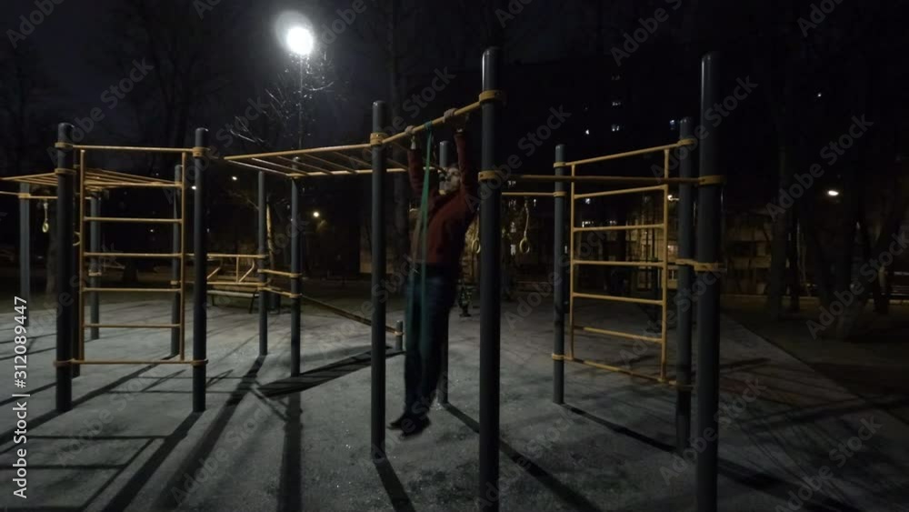 Timelapse Man working out on sports ground at night time Timelapse Man working out on sports ground at night time