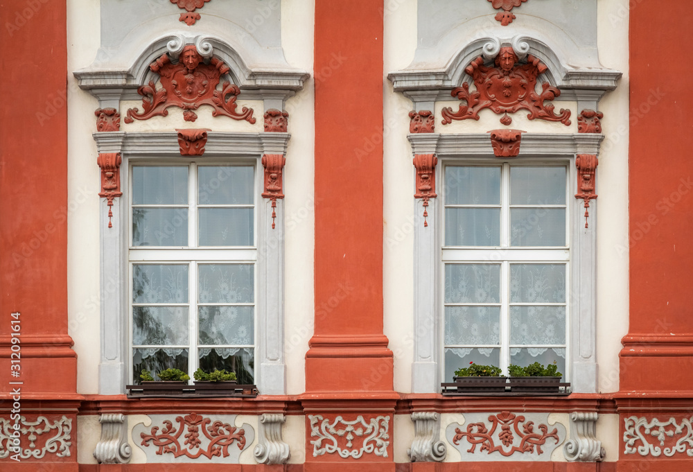 Red facade of the old house. The Windows and decoration of walls in Litomerice, Czechia