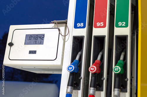 Gas station column with three pistols and screen display. Side front view.