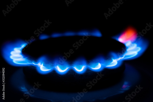 Blue flame of a gas stove in the dark