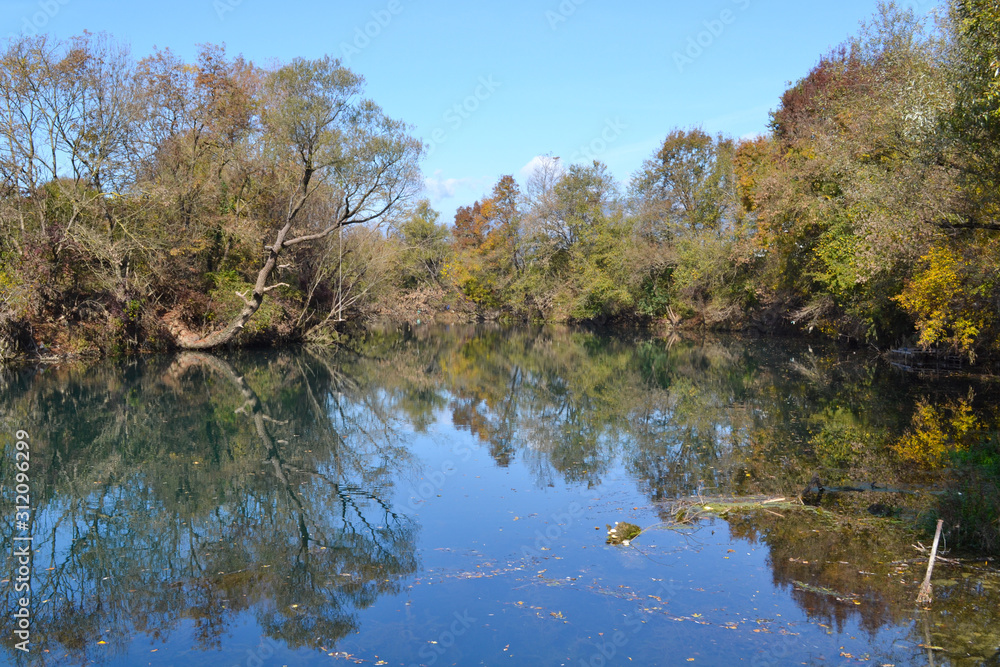 Fall colors reflectio in blue river. Vivid nature Fall colors reflectio in blue river. Vivid nature