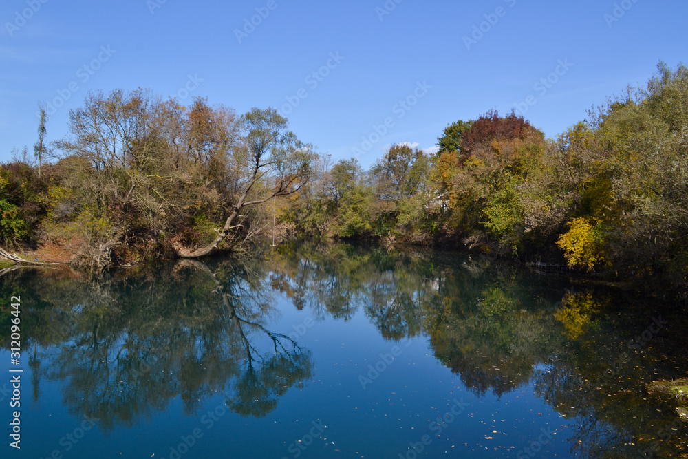 Fall colors reflectio in blue river. Vivid nature Fall colors reflectio in blue river. Vivid nature