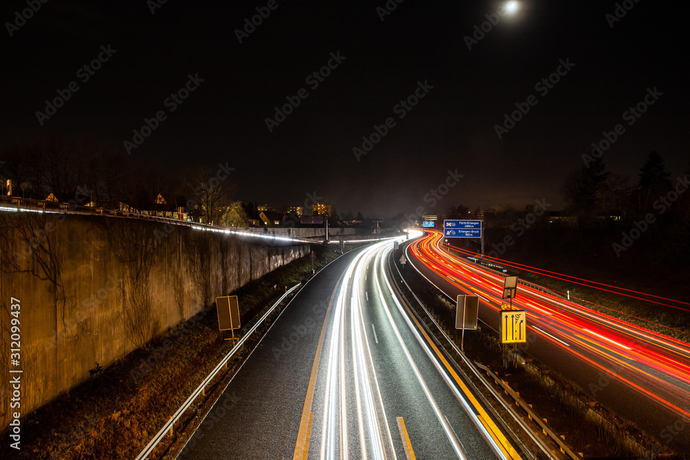 traffic in city on german highway at night in erlangen