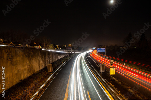 traffic in city on german highway at night in erlangen photo