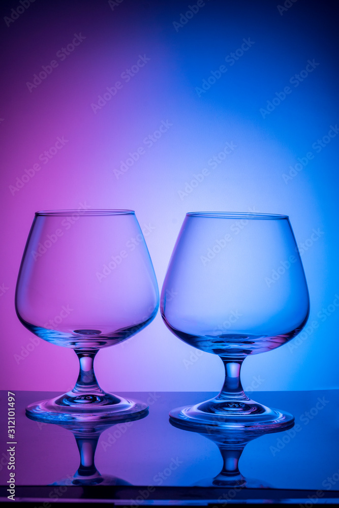 Two glass glasses on a colored background Two glass glasses on a colored background